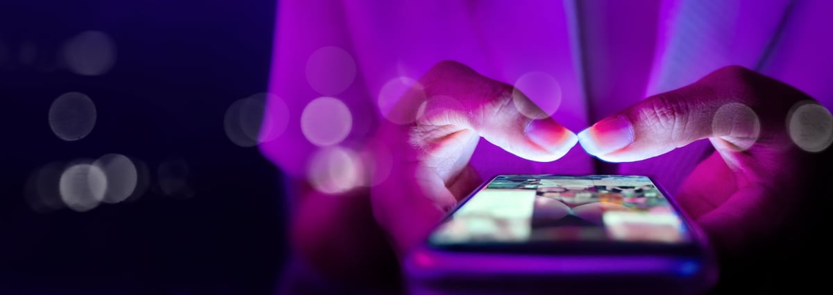 Businesswoman using smartphone for social media marketing and portfolio updates