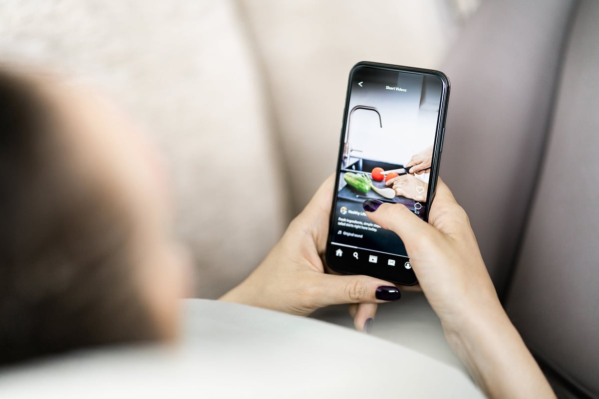 Social media reel content — watching short investment tips and viral finance content on smartphone